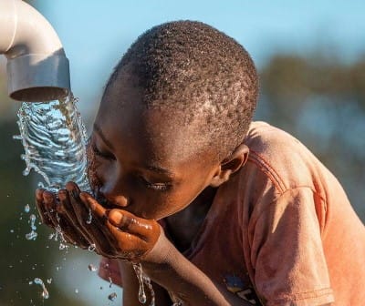 enpoverished kid drinking water
